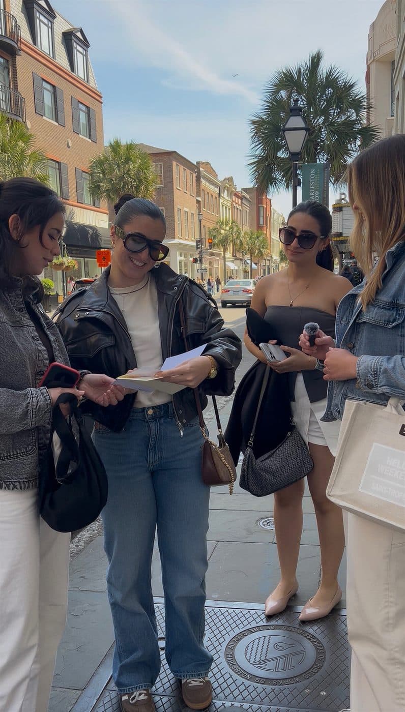 A card handed between friends outdoors