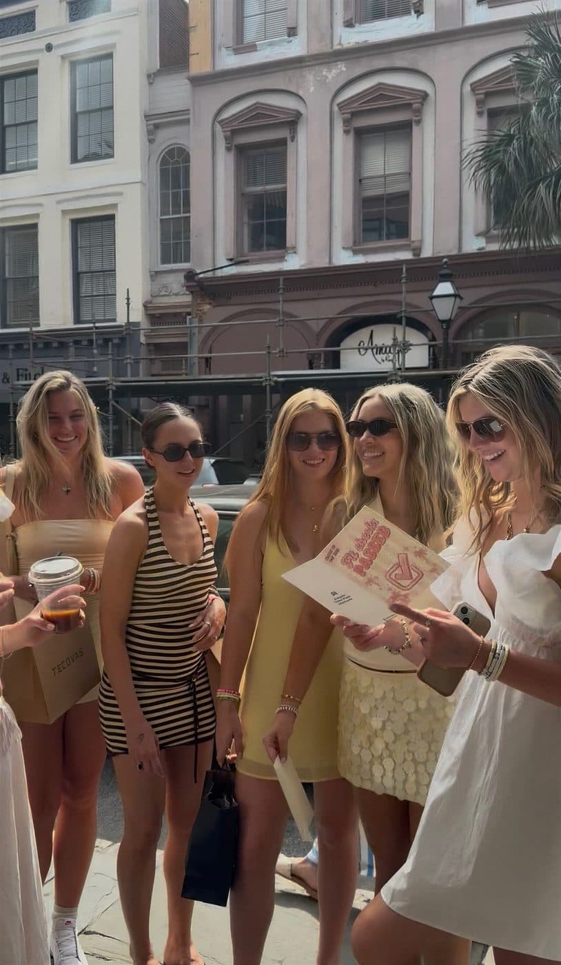 A group of friends gathered around a P.S. card