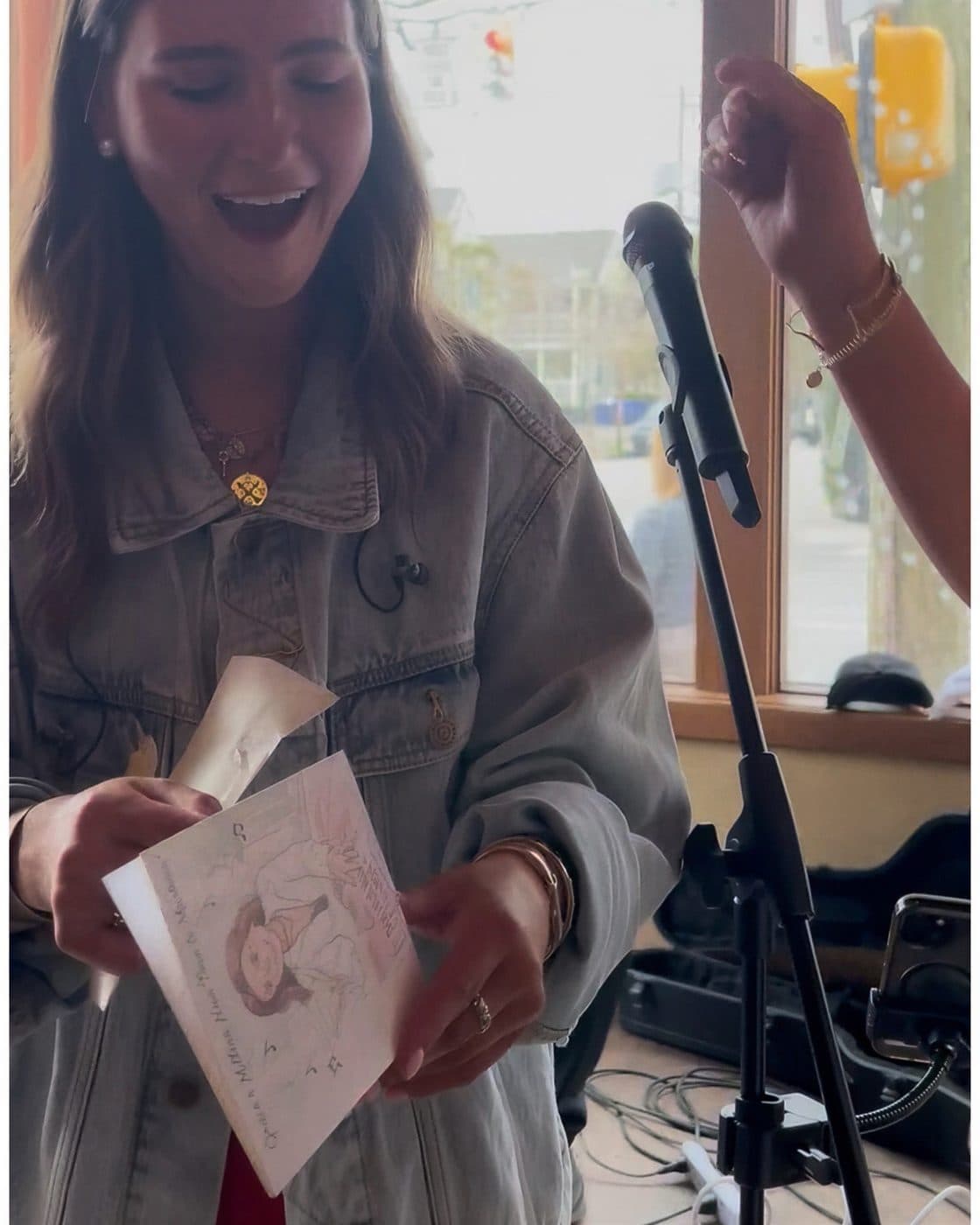 Woman gasping with joy as she opens a handmade card